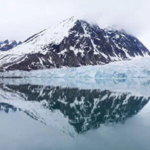 Reflections of mountains and Monaco glacier, Spitsbergen, Svalbard, Norway