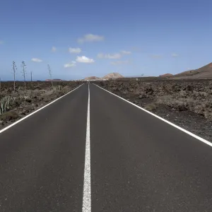 Road through volcanic landscape, near Mancha Blanca, Lanzarote, Canary Islands, Spain