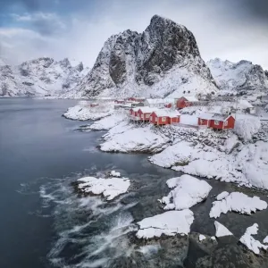 Rorbuer fishermens cabins on the snowy fjord, village view of the fishing village Hamnoy Rorbuer fishermens cabins on the snowy fjord, village view of the fishing village Hamnoy
