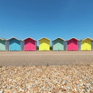 A Row of Multi-Coloured Beach Huts along the Promenade, Eastbourne, East Sussex