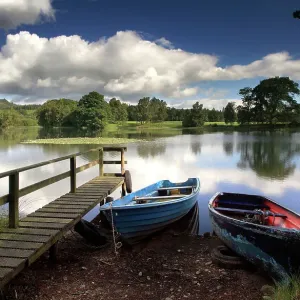 Two rowing boats tied to wooden pier Two rowing boats tied to wooden pier