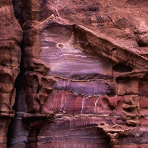 A rugged rock wall of colourful sandstone