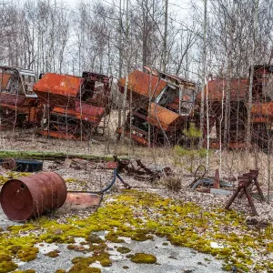 Rusty harvesters in an abandoned farm. Chernobyl zone, Ukraine