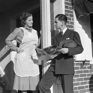 Salesman At Door Of A House Wife Showing Her A Bro Salesman At Door Of A House Wife Showing Her A Bro