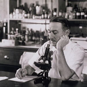 Scientist doing research in lab, 1930s (B&W)