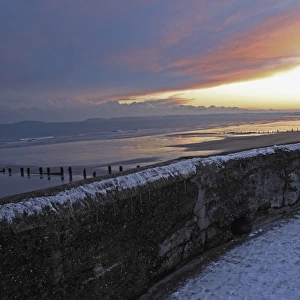 sea wall in winter at sunset