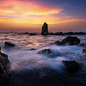 Sea wave hit the rock at sunset in Pattaya