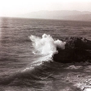 Sea waves crashing against rock