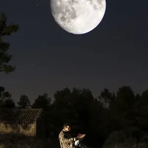 Seated Man Reading in Moonlit Nature Reserve Print Seated Man Reading in Moonlit Nature Reserve Print