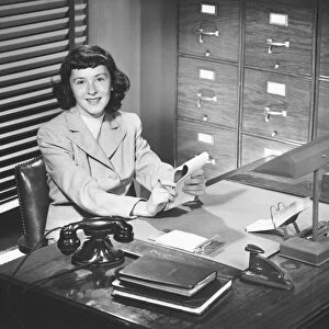 Secretary working in office, (B&W)