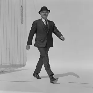 Senior man walking in full suit, portrait, smiling