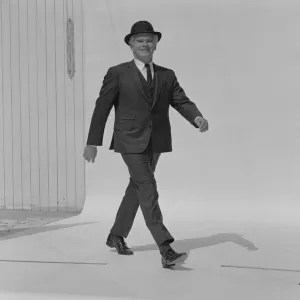 Senior man walking in full suit, portrait, smiling