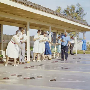 Senior people playing shuffleboard