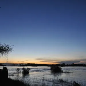 Serene view overlooking The Victoria Falls in Zambia at sunset Serene view overlooking The Victoria Falls in Zambia at sunset