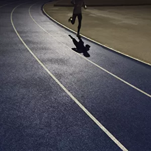 Shadow of a runner on a running track