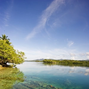 Shallow sea with coral, islands and sky