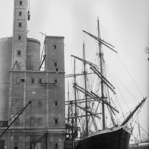 Ship And Silo Print: A sailing barque unloading grain at Millwall Docks