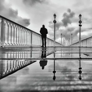 Silhouette on a pier on a rainy winter morning