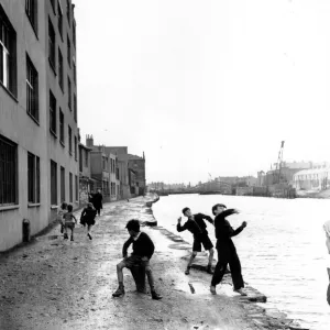 Skimming Stones; A group of children playing in the racially diverse dockland area of Cardiff