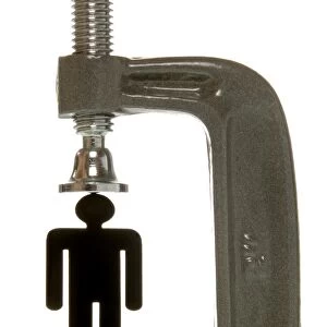 Small black female figurine in a screw clamp, symbolic image for being under pressure to perform