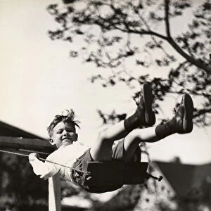 Small boy on swing outdoors
