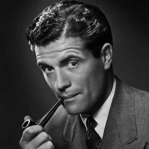 A smartly-dressed man smoking a pipe, circa 1950. (Photo by Retrofile/Hulton Archive/Getty Images)