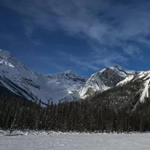 Snow on the rugged Canadian Rocky Mountains and a snow covered field, Yoho National Park