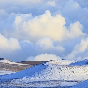 Snowy hilltops and clouds