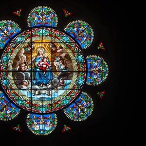 Stained Glass Rose Window featuring the Virgin Mary and her son Jesus Christ in the