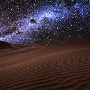 Starry night over the dunes in the desert