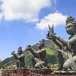 Statues of Devas making offerings at Tian Tan Buddha image at Po Lin Monastery, Lantau Island, Hong Kong, China