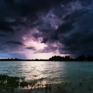Storm clouds over a quarry lake with water plants, near Mindelheim, Unterallgau, Allgau, Bavaria, Germany Storm clouds over a quarry lake with water plants, near Mindelheim, Unterallgau, Allgau, Bavaria, Germany
