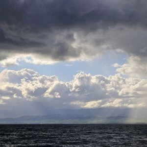 Storm clouds and sunbeams above Lake Geneva, Lac Leman, Evian-les-Bains, Haute-Savoie, Rhone-Alpes, France