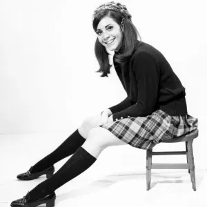 Studio portrait of young woman sitting on chair Studio portrait of young woman sitting on chair