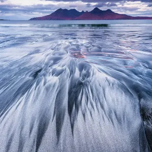 Stunning sand formations on the Isle of Eigg with the Isle of Rum in the distance. Scotland Stunning sand formations on the Isle of Eigg with the Isle of Rum in the distance. Scotland