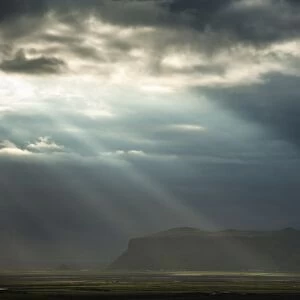 Sun rays shining through clouds, moody lighting, South Coast, Iceland, Europe