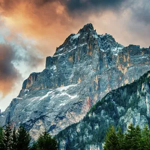 The sun sets on a peak in the Dolomite mountains of Italy The sun sets on a peak in the Dolomite mountains of Italy