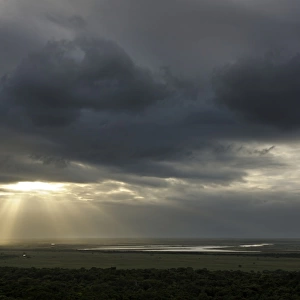 Sunbeams breaking through a dark cloudy over a wetland, iSimangaliso Wetland Park, Kwazulu-Natal, South Africa