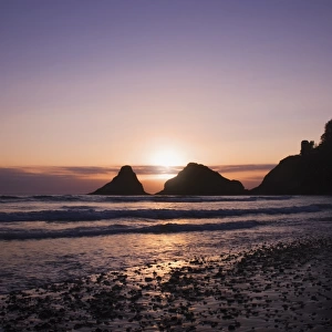 Sunset Behind Offshore Rocks Along The Oregon Coastline
