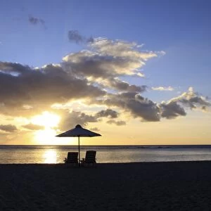 Sunset on the public beach of Flic en Flac on the western coast of Mauritius, Africa
