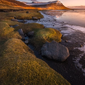 Sunset at Rock beach in West fjord Iceland
