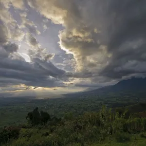 Sunset over the Virunga Mountains of the Volcanoes National Park in Rwanda with the rural settlements dotting the landscape