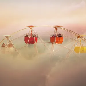 Surreal picture of colorful ferris wheel emerging from the clouds Surreal picture of colorful ferris wheel emerging from the clouds