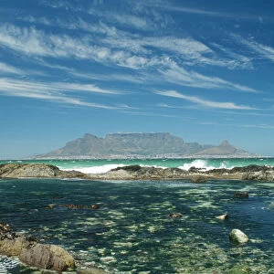 Table Mountain across the bay with rock pool in foreground