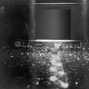 Theatre audience looking at screen, rear view (B&W)