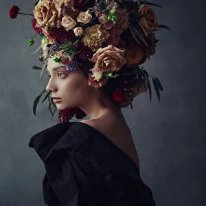 Thoughtful young woman in floral headdress