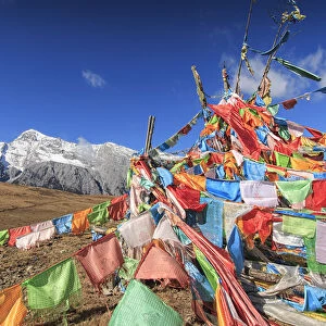 Tibetan Prayer Flags on foreground and Jade Dragon Snow Mountain on background