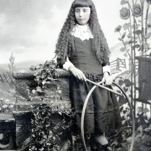 Tintype of girl posing with hoop and stick game