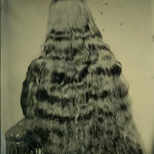 Tintype photograph from 1870s of back of woman's head, long black hair