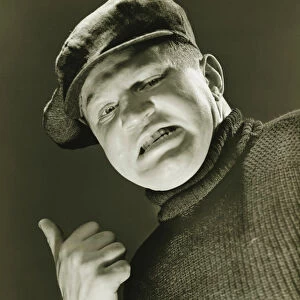 Tough guy showing thumb up, (B&W), close-up, portrait, low angle view